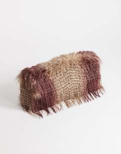 Model wearing Ciara oversized large folded faux fur structured clutch bag in burgundy mix