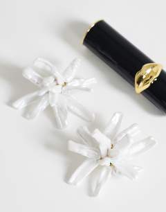 Model wearing Ciara statement pearl flower earrings in white and gold