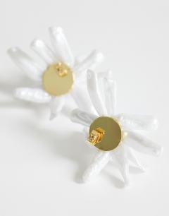 Model wearing Ciara statement pearl flower earrings in white and gold