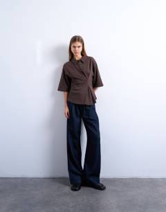 Model wearing Cinch detail structured polo in chocolate brown