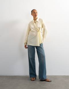 Model wearing Cinch front detail shirt in yellow stripe