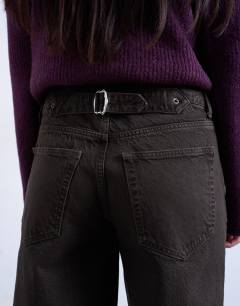 Model wearing Cinch low rise jean in chocolate