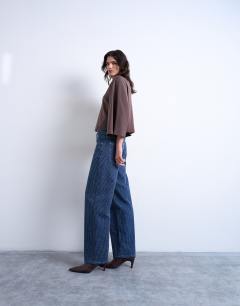 Model wearing Cinch low rise jean in textured stripe detail indigo rinse