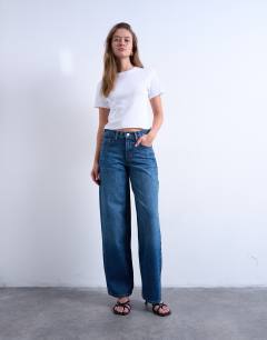 Model wearing Cinch low rise jeans in dark stone wash