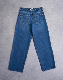 Model wearing Cinch low rise jeans in dark stone wash