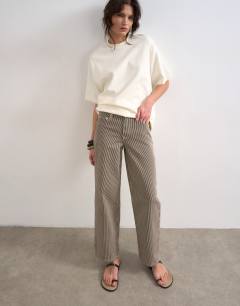 Model wearing Cinch low rise relaxed fit jean in choc stripe