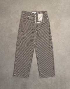Model wearing Cinch low rise relaxed fit jean in choc stripe