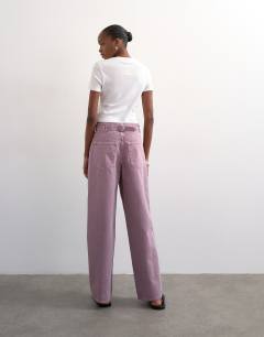 Model wearing Cinch low rise relaxed fit jean in purple