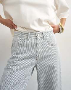 Model wearing Cinch low rise relaxed jean in blue and white stripe
