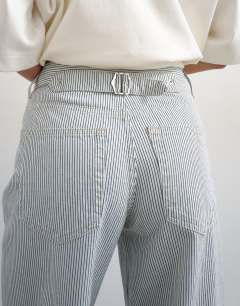 Model wearing Cinch low rise relaxed jean in blue and white stripe