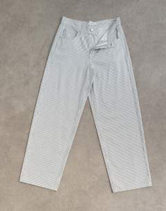 Model wearing Cinch low rise relaxed jean in blue and white stripe