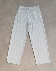 Model wearing Cinch low rise relaxed jean in blue and white stripe