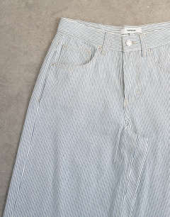 Model wearing Cinch low rise relaxed jean in blue and white stripe