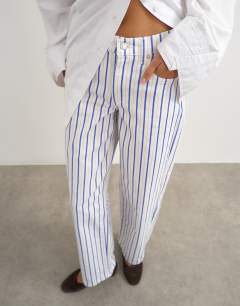 Model wearing Cinch low rise relaxed jean in blue & lilac stripe 