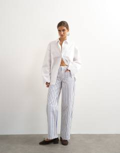 Model wearing Cinch low rise relaxed jean in blue & lilac stripe 