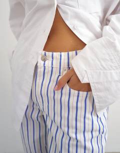 Model wearing Cinch low rise relaxed jean in blue & lilac stripe 