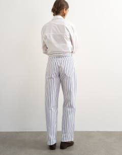Model wearing Cinch low rise relaxed jean in blue & lilac stripe 