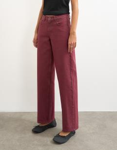 Model wearing Cinch low rise relaxed jean in cherry red