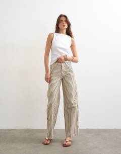 Model wearing Cinch low rise relaxed jean in ecru and black stripe