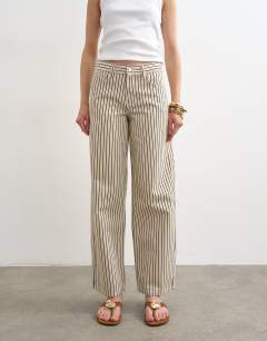 Model wearing Cinch low rise relaxed jean in ecru and black stripe