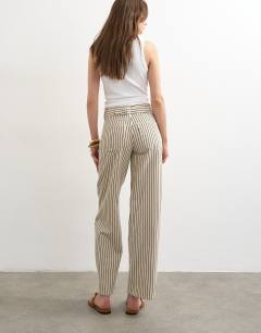 Model wearing Cinch low rise relaxed jean in ecru and black stripe