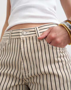 Model wearing Cinch low rise relaxed jean in ecru and black stripe