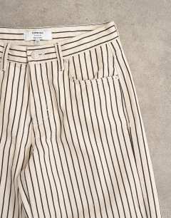 Model wearing Cinch low rise relaxed jean in ecru and black stripe