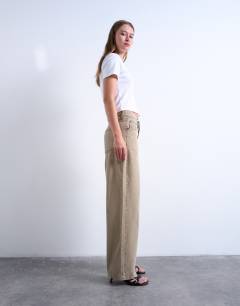 Model wearing Cinch low rise relaxed jean in latte