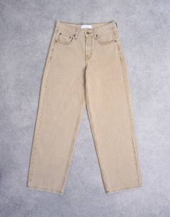 Model wearing Cinch low rise relaxed jean in latte