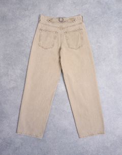 Model wearing Cinch low rise relaxed jean in latte