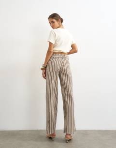 Model wearing Cinch low rise relaxed jean in tobacco and colbalt stripe