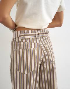 Model wearing Cinch low rise relaxed jean in tobacco and colbalt stripe