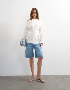 Model wearing Cinch off the shoulder top in white