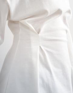 Model wearing Cinch off the shoulder top in white