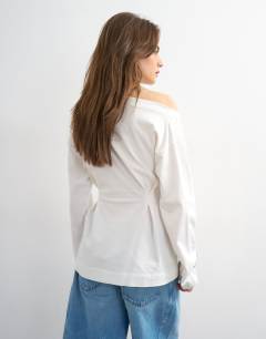 Model wearing Cinch off the shoulder top in white
