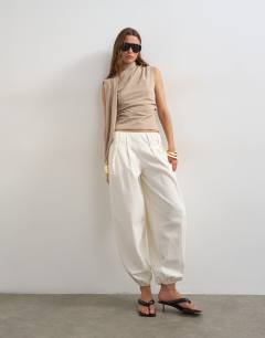 Model wearing Cinch waist scarf detail top in stone