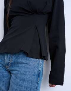 Model wearing Cinch waist structured long sleeve tee in black