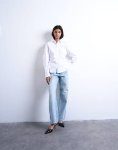 Model wearing Cinch waisted long sleeve shirt in white