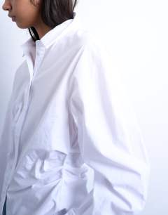 Model wearing Cinch waisted long sleeve shirt in white