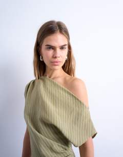 Model wearing Cinched waist grown on neck mini dress in green stripe