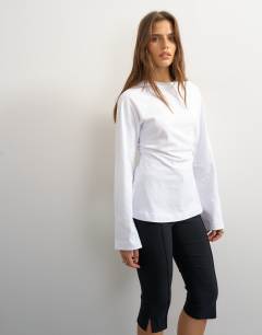 Model wearing Cinched waist long sleeve raglan t-shirt in white