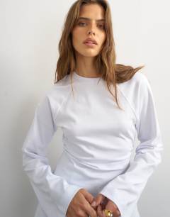 Model wearing Cinched waist long sleeve raglan t-shirt in white