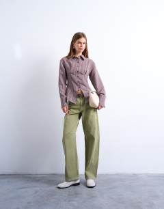 Model wearing Cinched waist shirt with cut away placket in burgundy stripe