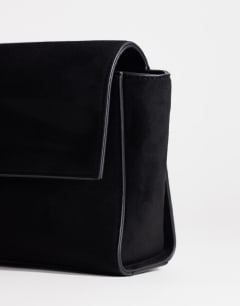 Model wearing Clark medium suedette fold over clutch bag in black