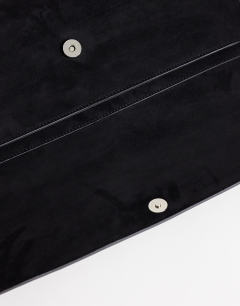 Model wearing Clark medium suedette fold over clutch bag in black