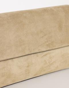 Model wearing Clark medium suedette fold over clutch bag in sand
