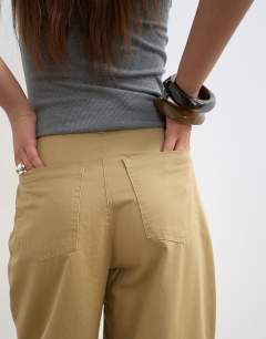 Model wearing Clean cargo trouser with rolled hem in tan