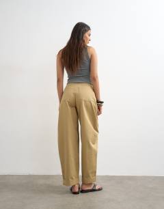Model wearing Clean cargo trouser with rolled hem in tan