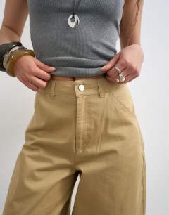 Model wearing Clean cargo trouser with rolled hem in tan
