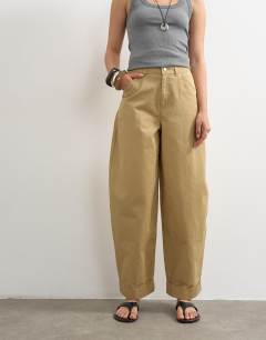 Model wearing Clean cargo trouser with rolled hem in tan